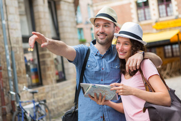Young couple of tourists visiting city