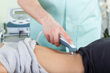 Woman during laser physiotherapy