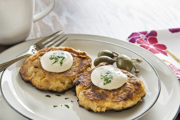 Crab cakes with a creamy mustard sauce and fresh parsley