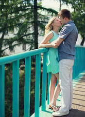 Sweet young couple kissing in the city summer