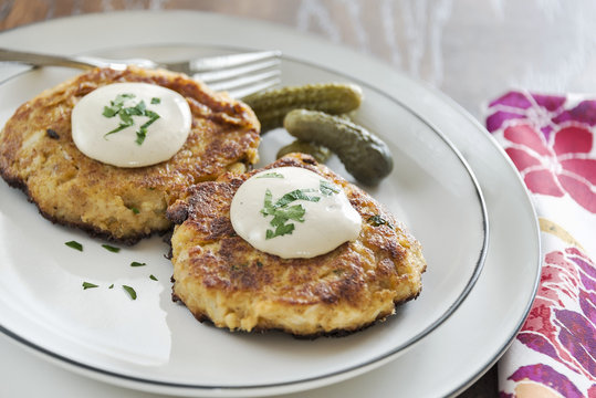 Crab cakes with a creamy mustard sauce and fresh parsley