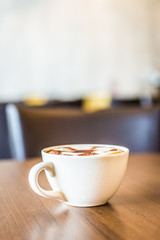 Coffee cup in coffee shop interior