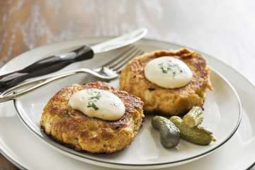 Crab cakes with a creamy mustard sauce and fresh parsley