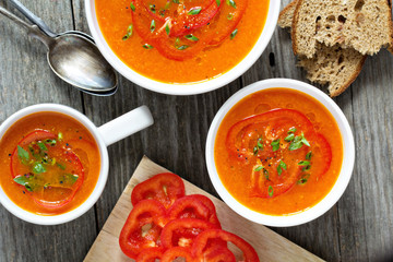 Roasted red peper soup in white bowl