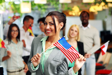 Patriotic businesswoman standing with USA flag 