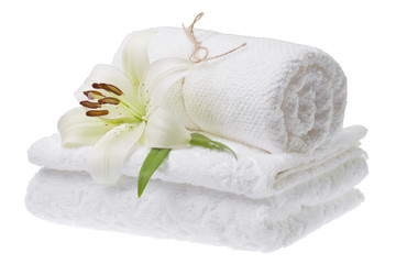 Stack of white towels with lily, isolated