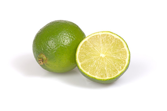 Whole citrus lime and half on the white background.