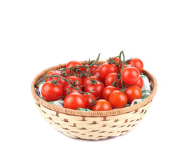 Wicker basket full of tomatoes.