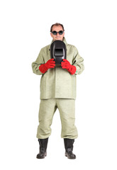 Worker holding welder protective mask.