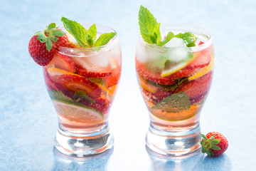 cocktail with fresh strawberries and citrus in glasses