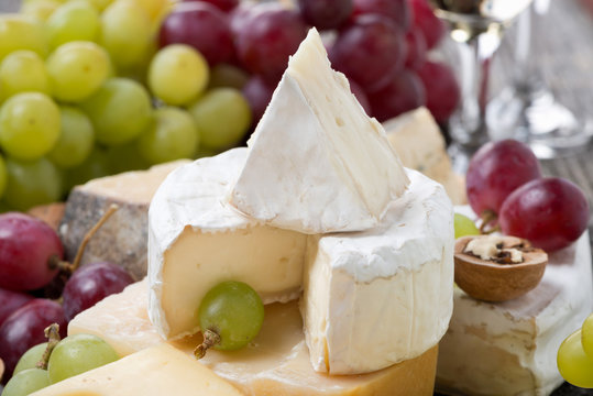 Camembert, different cheeses and grapes
