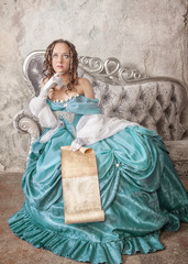Beautiful woman in medieval dress with scroll letter