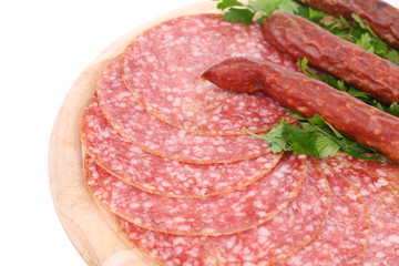 Composition of sausages on wooden platter.