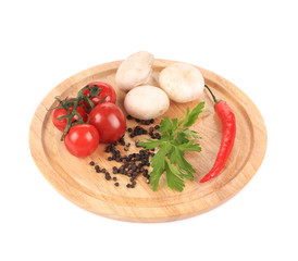 Fresh vegetables on wooden platter.