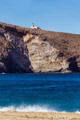 Fototapeta na wymiar Lighthouse in Achla beach, Andros Greece