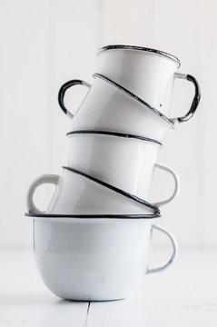 five white enameled mugs