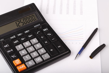 Business Charts with calculator and pen