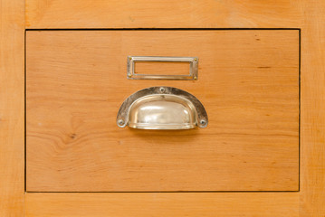 a single old cabinet drawer with metal handle