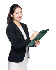 Asian businesswoman write on clipboard