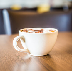Coffee cup in coffee shop interior
