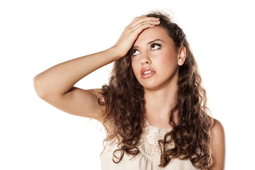 Fototapeta premium disappointed young girl holding a hand on forehead