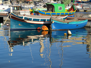 Fototapeta na wymiar Colourful painted fishing boats in Msida creek harbour, Malta