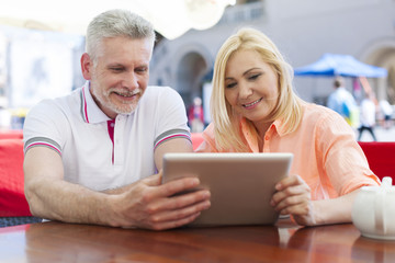 Smiling mature couple enjoying the wireless internet