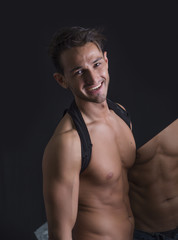 Fototapeta premium Smiling shirtless man holding mirror