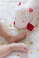 Babie's feet with her doll