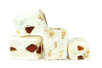 Soft nougat with peanuts and fruits on a white background