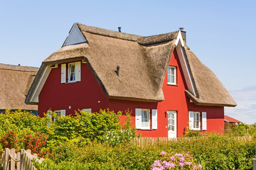Fototapeta na wymiar red thatched-roof vacation house