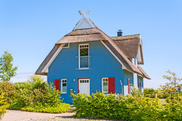Fototapeta na wymiar Vacation home, thatched-roof house