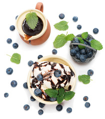 ice cream with mint and blueberries in  bowl  with chocolate sa