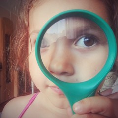 Cute kid using magnifying glass