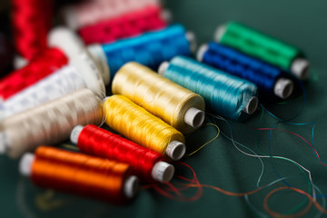 Background of the reels with colorful threads.