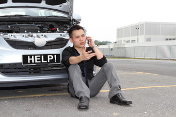 Fototapeta A man calling for help to repair a stalled car obraz
