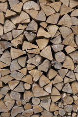 firewood background - chopped firewood on a stack