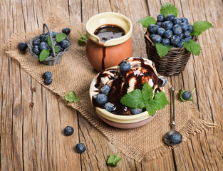 ice-cream, fresh blueberries and mint leaves on ceramic bowl, o