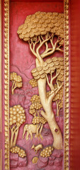 Fototapeta na wymiar Old wooden door carved Thailand gold.