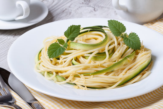 spaghetti pasta with zucchini and cheese on a plate