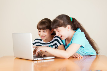 Fototapeta na wymiar Two Cute Little School Girls With Laptop