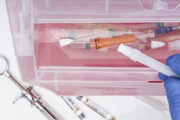 Inserting Medical / Dental waste into sharps container