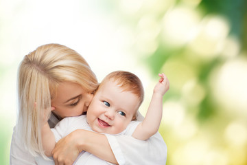 happy mother kissing smiling baby