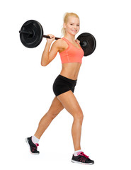 smiling sporty woman exercising with barbell