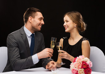 couple with glasses of champagne at restaurant