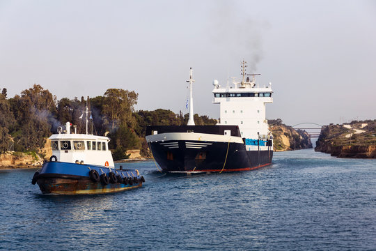 Cargo ship and tugboat crossing Corinth canal, Greece