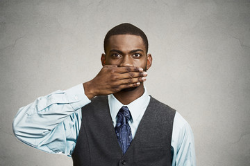 Man covers his mouth, speak no evil concept