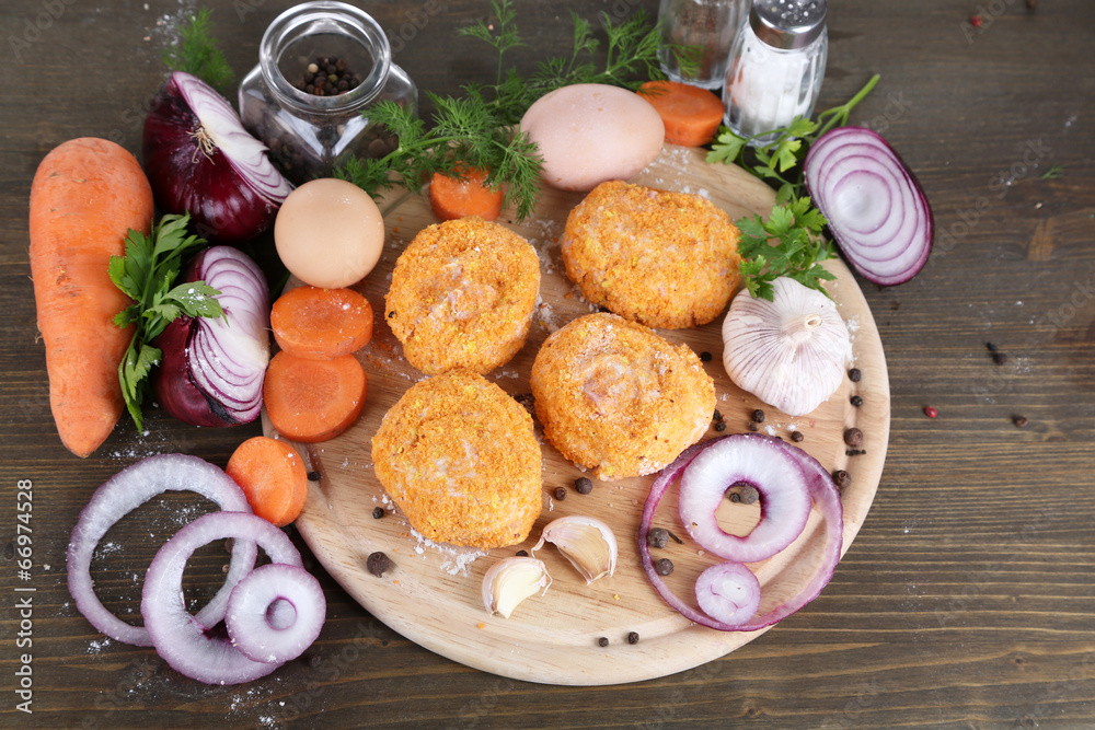 Poster Meat patties on board on wooden table