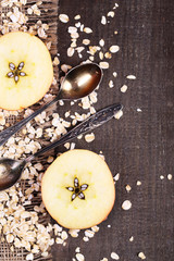 Apple with oatmeal and vintage spoons