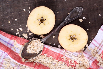 Apple with oatmeal and vintage spoons